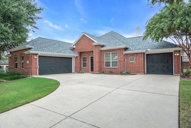 ranch-style home with a garage and a front lawn