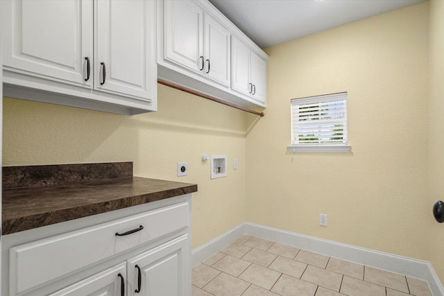 laundry area with cabinets, electric dryer hookup, hookup for a washing machine, and light tile patterned floors