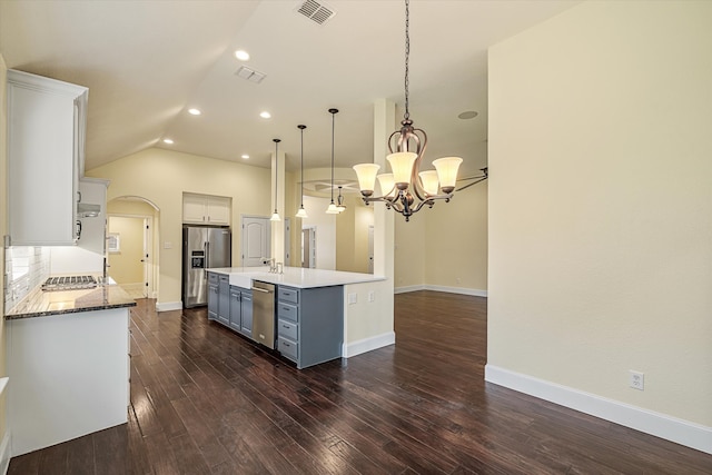 kitchen featuring appliances with stainless steel finishes, pendant lighting, an island with sink, and white cabinets