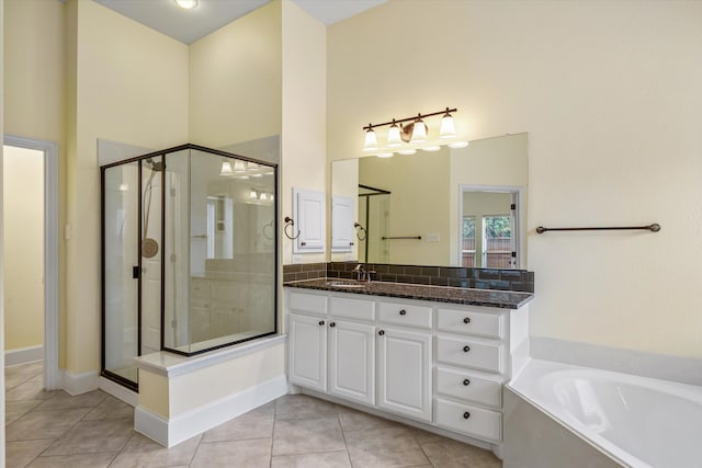 bathroom with shower with separate bathtub, tile patterned flooring, and vanity