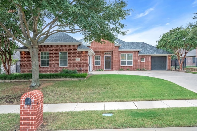 view of front of property with a front yard and a garage