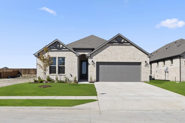 view of front of house featuring a front yard and a garage