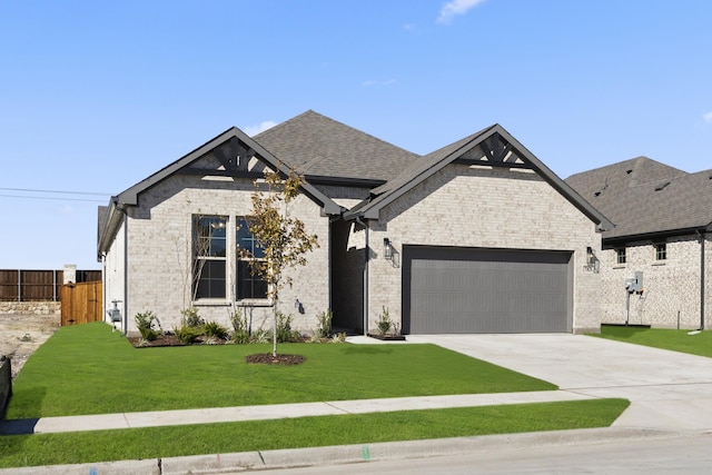 view of front of property featuring a front lawn and a garage