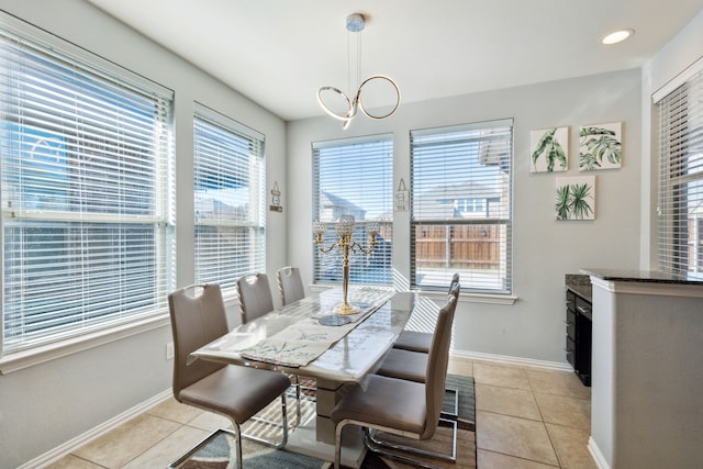 tiled dining area featuring an inviting chandelier