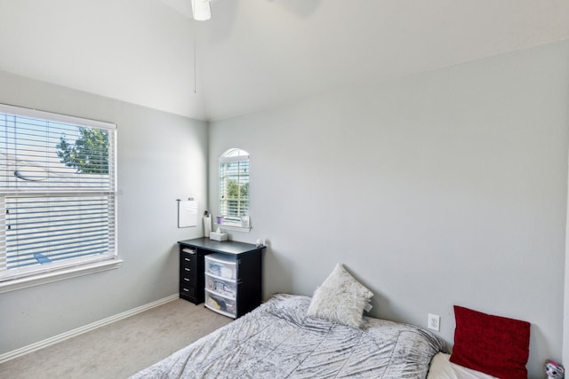 carpeted bedroom featuring ceiling fan, lofted ceiling, and multiple windows