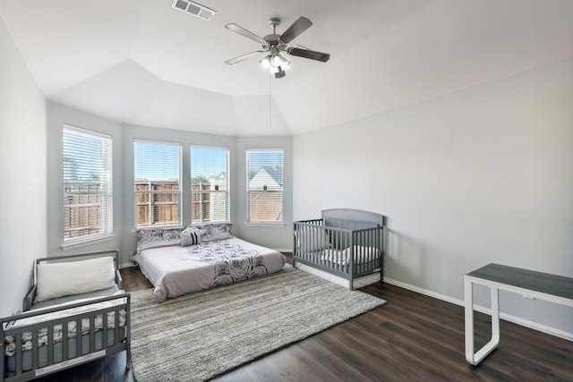 bedroom featuring lofted ceiling, dark hardwood / wood-style flooring, and ceiling fan