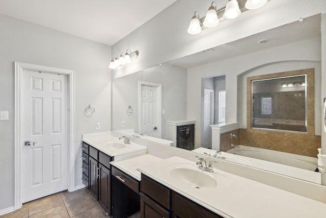 bathroom with vanity, tile patterned flooring, and a tub