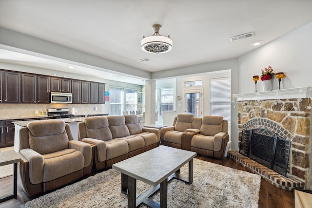 living room featuring hardwood / wood-style flooring and a fireplace