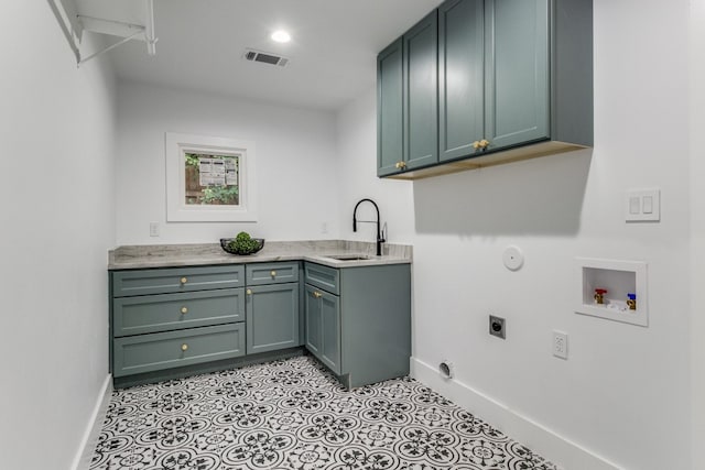 laundry room featuring washer hookup, sink, hookup for an electric dryer, hookup for a gas dryer, and cabinets