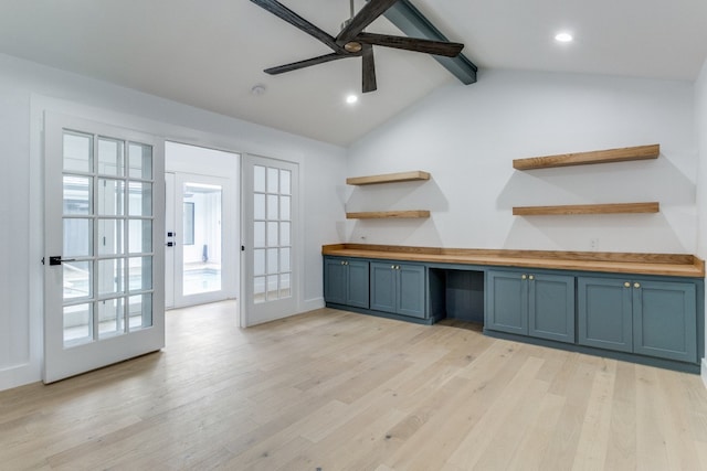 kitchen featuring light hardwood / wood-style floors, ceiling fan, wood counters, built in desk, and vaulted ceiling with beams