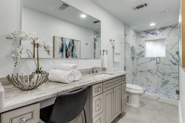 bathroom with tile patterned flooring, an enclosed shower, vanity, and toilet