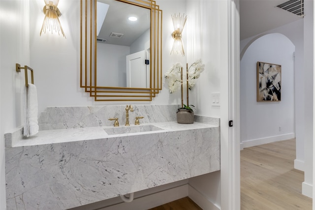 bathroom with hardwood / wood-style flooring and sink