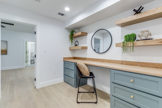 office area with light wood-type flooring and built in desk