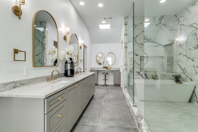 bathroom featuring independent shower and bath and vanity