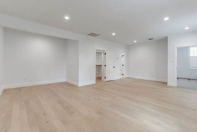 spare room featuring light wood-type flooring