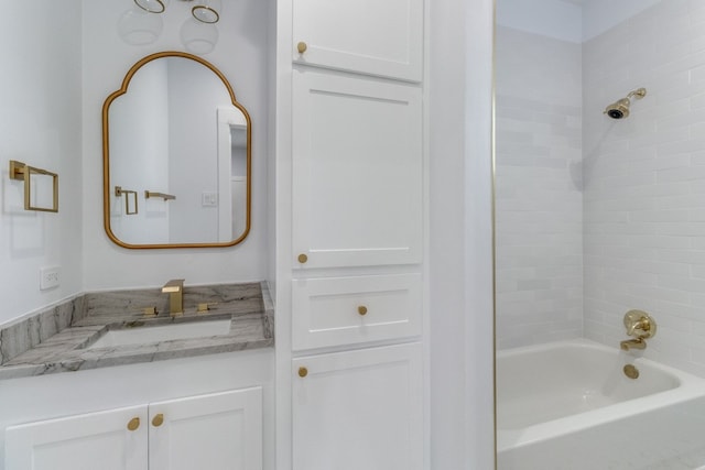 bathroom with vanity and tiled shower / bath combo