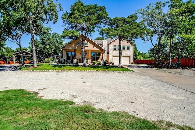 view of front facade with a front yard, a gazebo, and a garage