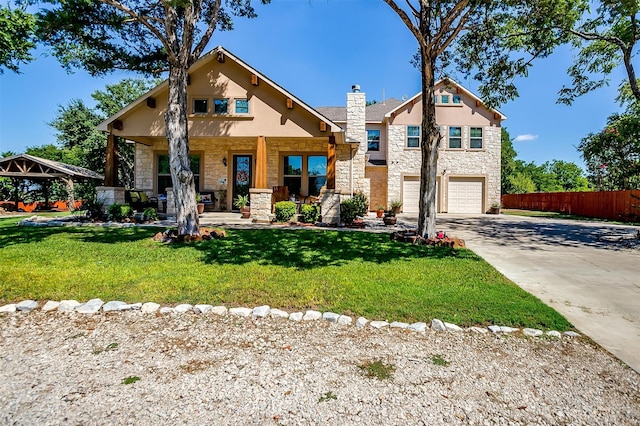 view of front of house featuring a garage, a gazebo, and a front lawn