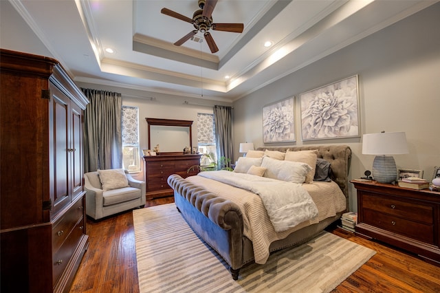 bedroom featuring a raised ceiling, ornamental molding, dark hardwood / wood-style floors, and ceiling fan