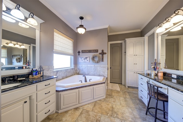 bathroom featuring vanity, ornamental molding, and a tub