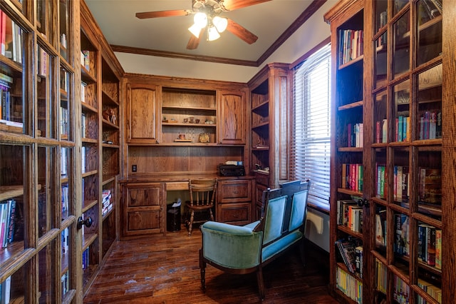 office area with ornamental molding, wood walls, ceiling fan, and dark hardwood / wood-style flooring