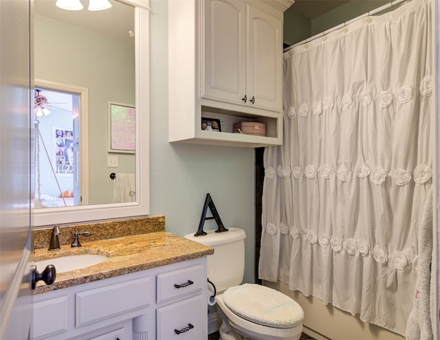 bathroom featuring ceiling fan, vanity, toilet, and curtained shower