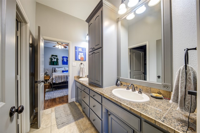 bathroom with tile patterned flooring, ceiling fan, and vanity