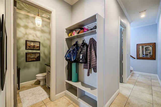 mudroom with ornamental molding and light tile patterned flooring