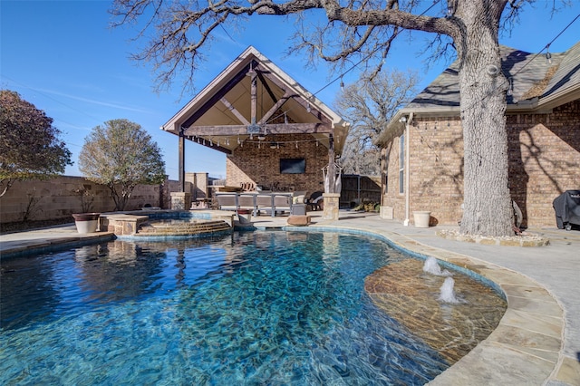 view of swimming pool featuring a patio and an in ground hot tub