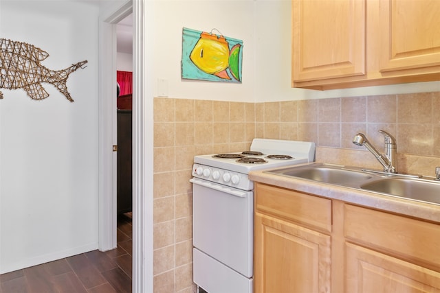 kitchen with light brown cabinets, white range, dark hardwood / wood-style floors, and sink