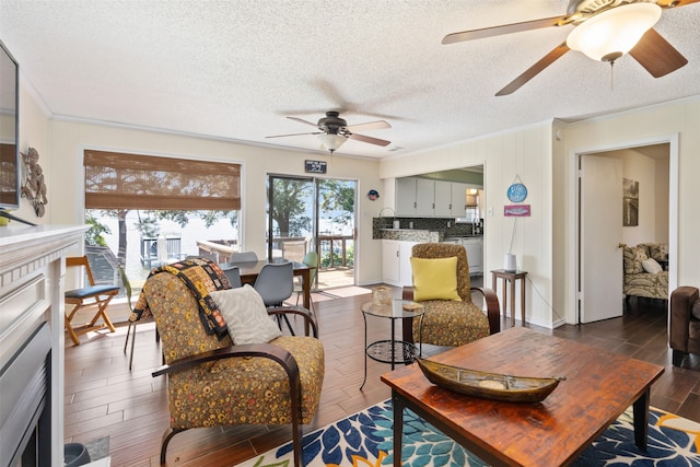 living room featuring ceiling fan, dark hardwood / wood-style floors, and a healthy amount of sunlight