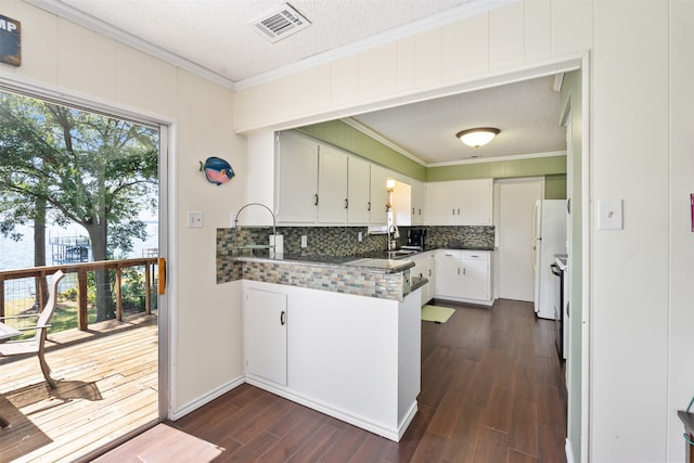 kitchen featuring ornamental molding, white cabinetry, and dark hardwood / wood-style floors