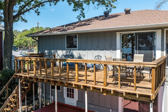 rear view of property featuring a wooden deck