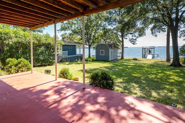 107 Briarwood Dr, Mabank, TX 75156 - view of patio with a water view, a boat dock, an outdoor structure, and a shed
