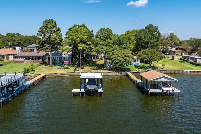 dock area with a lawn and a water view