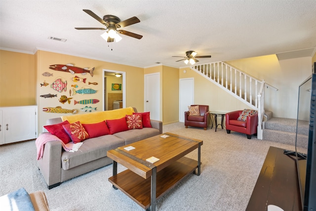 living room with ceiling fan, light colored carpet, a textured ceiling, and ornamental molding