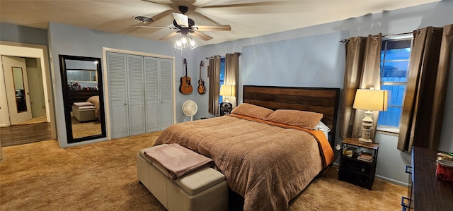 carpeted bedroom with ceiling fan and a closet