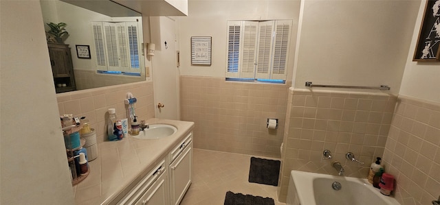 bathroom featuring tile walls, tile patterned floors, vanity, and a bathing tub