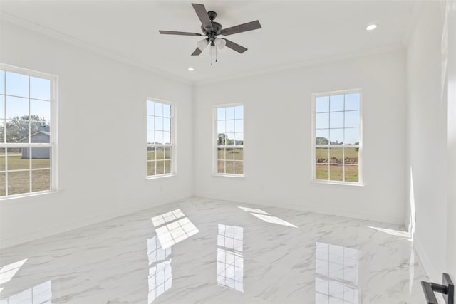 empty room featuring ceiling fan and crown molding