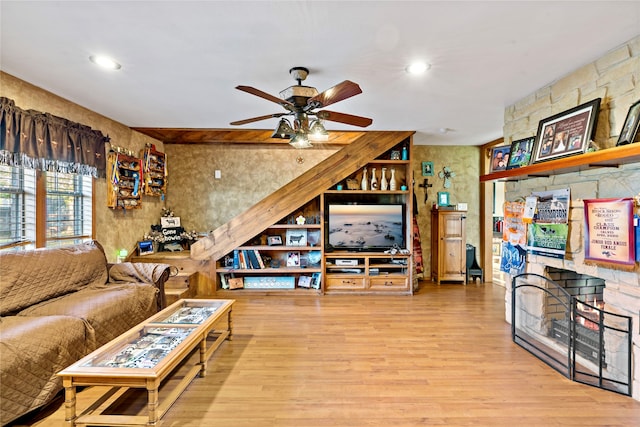 living room with ceiling fan and light hardwood / wood-style floors