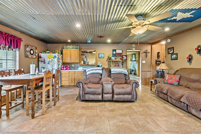 living room with ceiling fan and crown molding