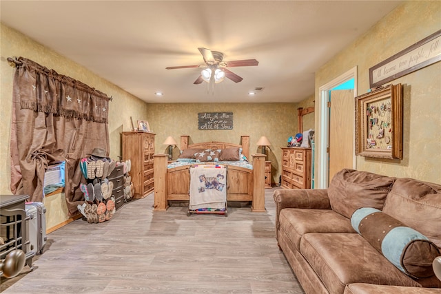 living room featuring ceiling fan and light wood-type flooring