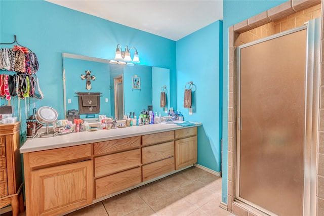 bathroom with walk in shower, vanity, and tile patterned floors