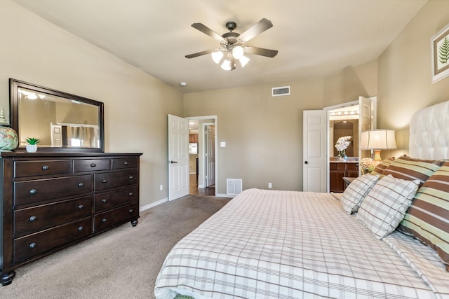 carpeted bedroom featuring connected bathroom and ceiling fan