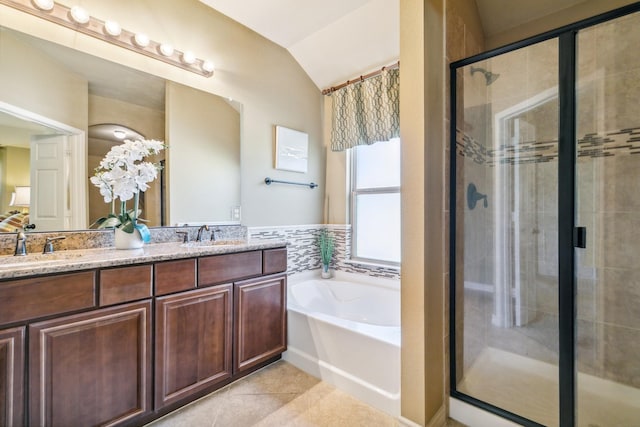 bathroom featuring tile patterned flooring, vanity, lofted ceiling, and shower with separate bathtub