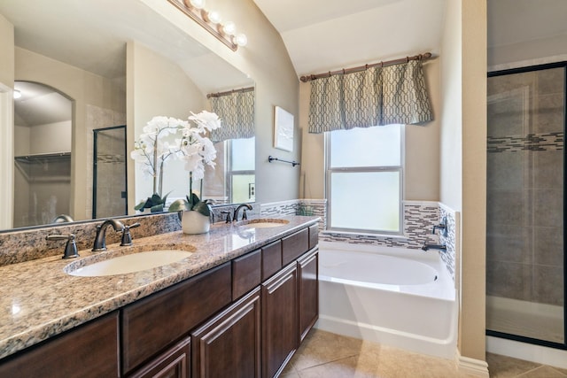 bathroom featuring tile patterned floors, a wealth of natural light, vanity, and independent shower and bath