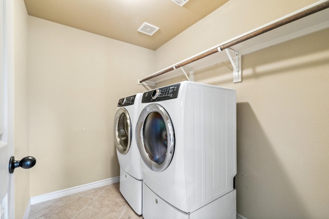 washroom featuring light tile patterned flooring and independent washer and dryer