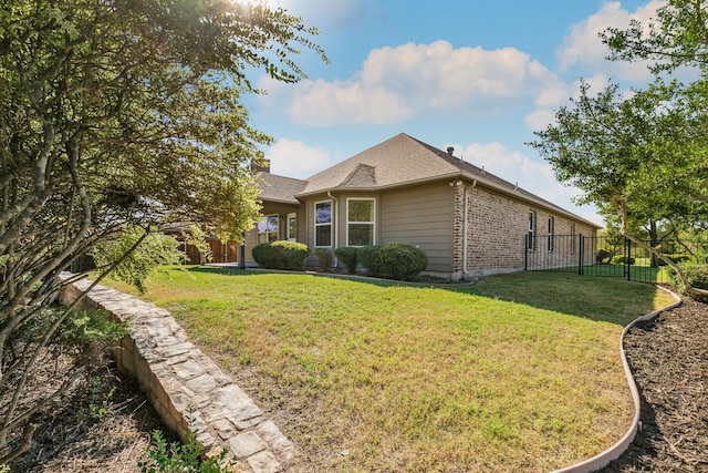 view of side of home featuring a yard