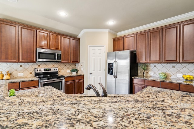 kitchen featuring tasteful backsplash, light stone countertops, stainless steel appliances, and ornamental molding