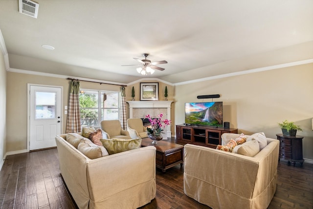 living room featuring lofted ceiling, crown molding, a brick fireplace, ceiling fan, and dark hardwood / wood-style flooring